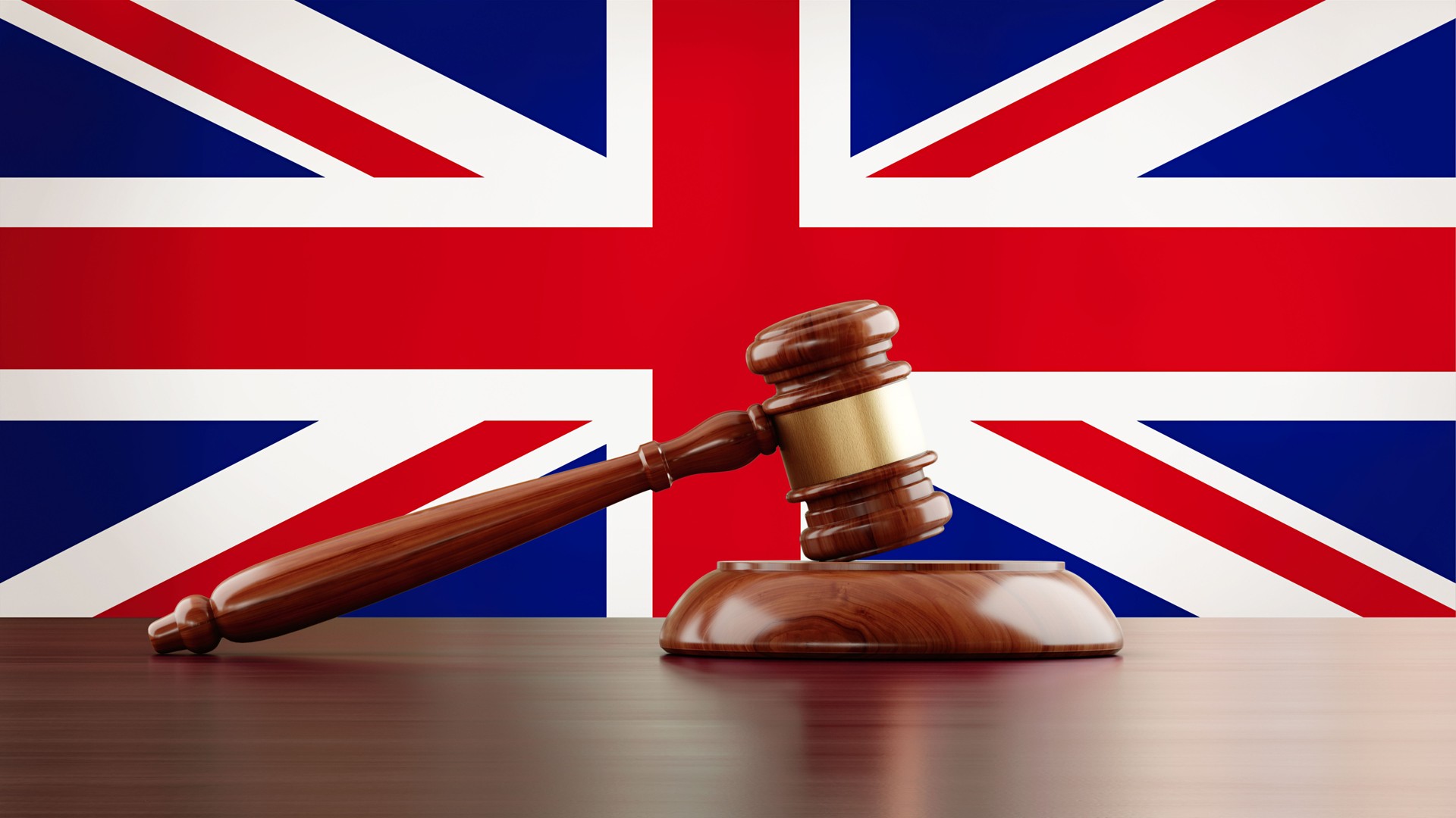 Wooden Gavel In Front Of British Flag