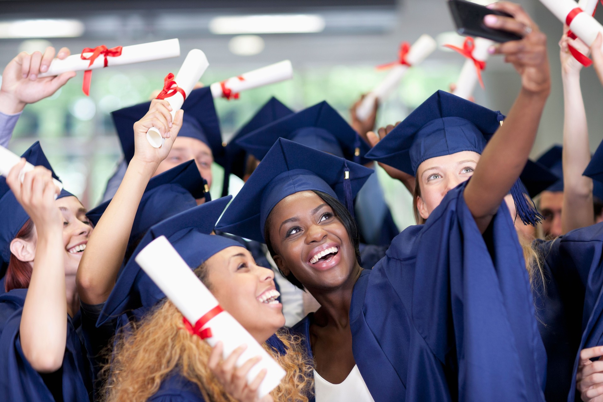 Students taking selfie after graduation ceremony