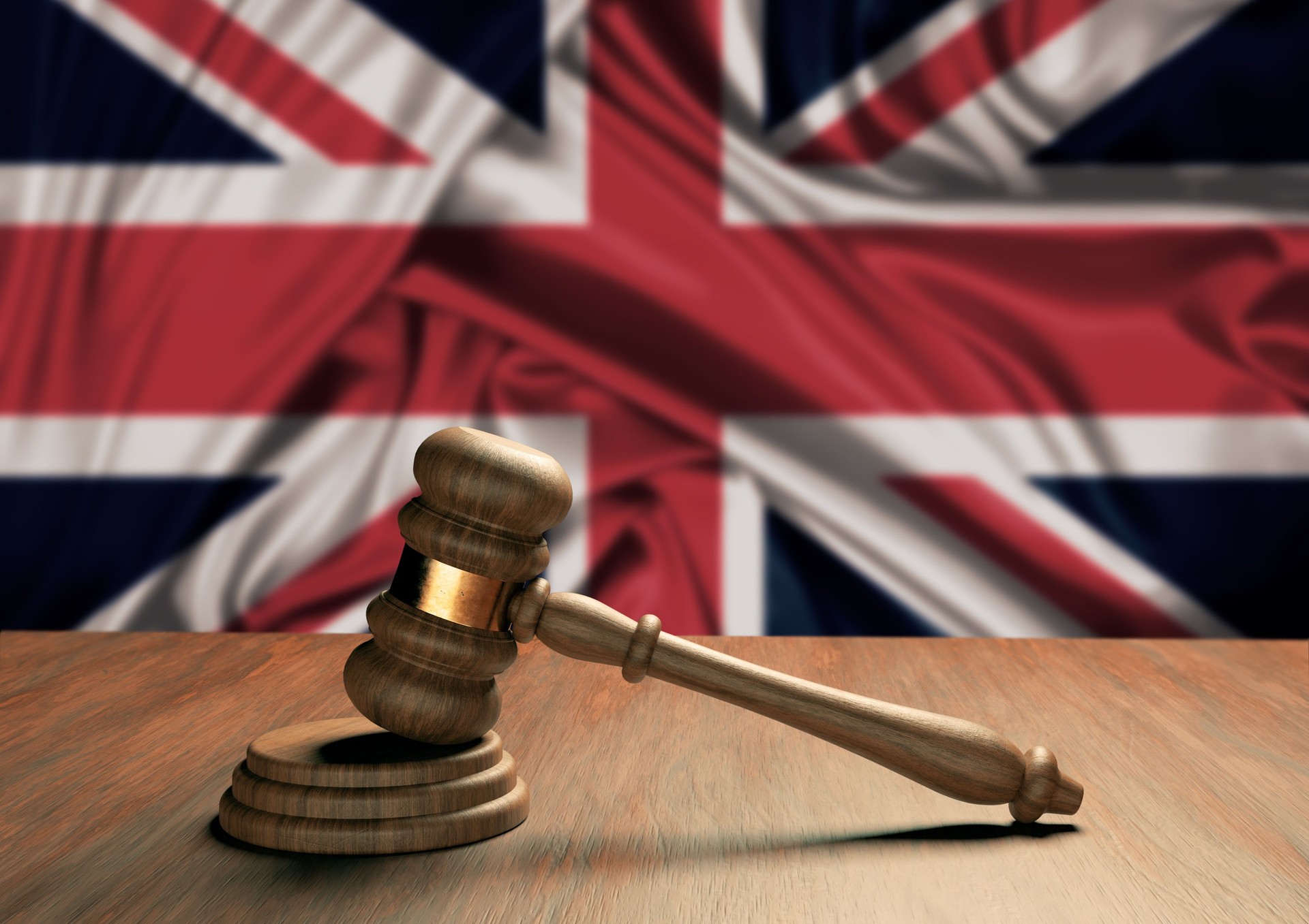 Wooden judge's gavel Symbol of law and justice with the flag of England. English Supreme Court.